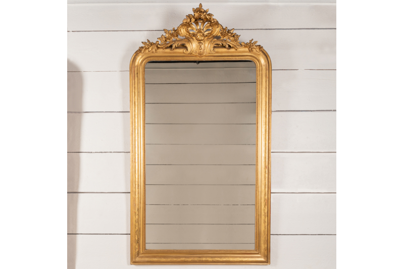 Very large mirror in gilded wood and engraved with floral motifs